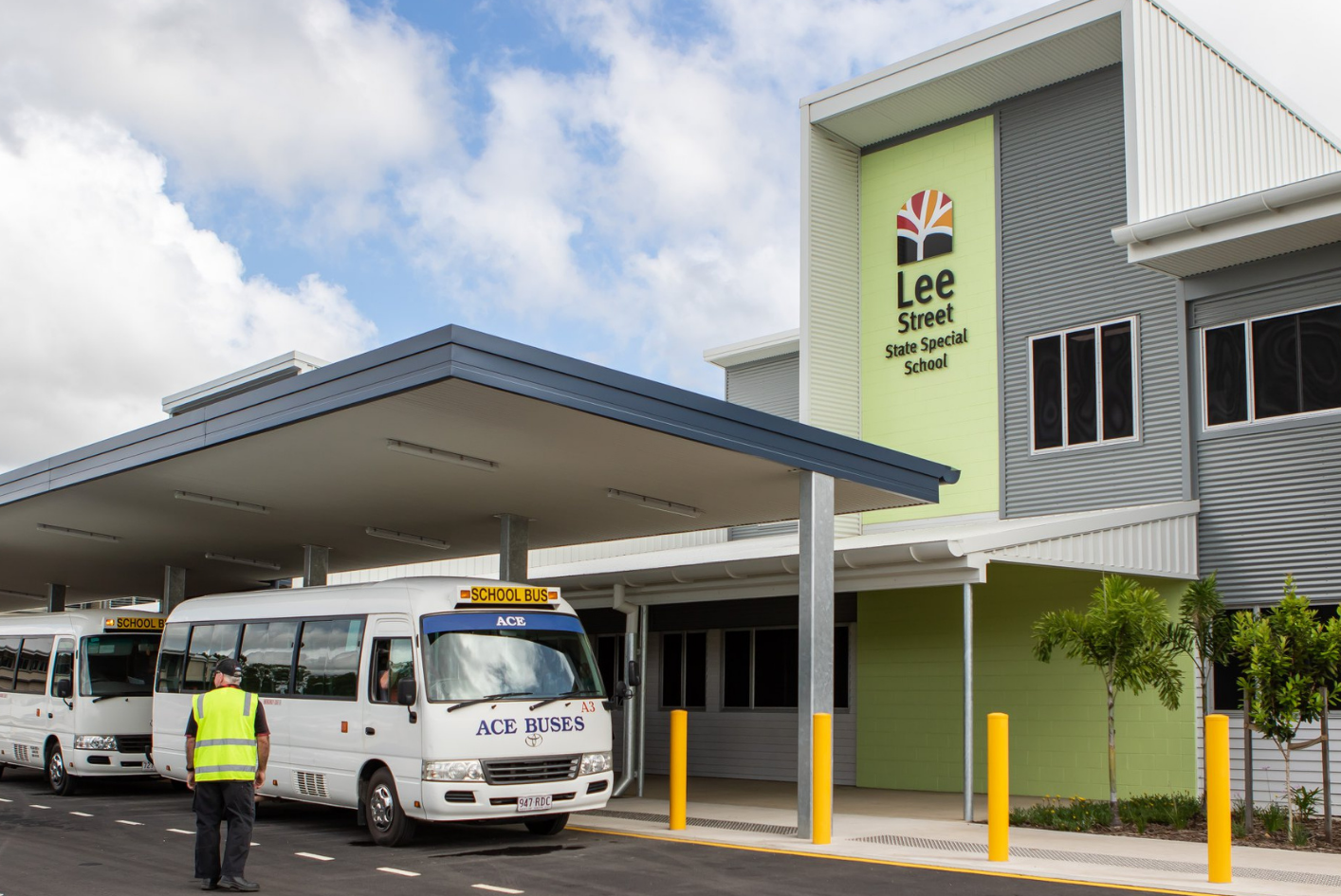 Two school buses parked outside Lee Street State Special School where Huff Group upgraded lighting, power, and data systems for safer, easier learning
