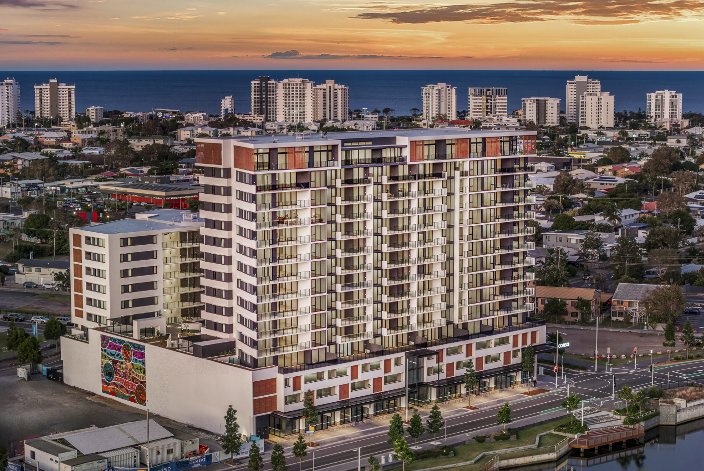 Sunset view of The Corso High-End Apartments, where Huff Group installed premium electrical and advanced building technology systems