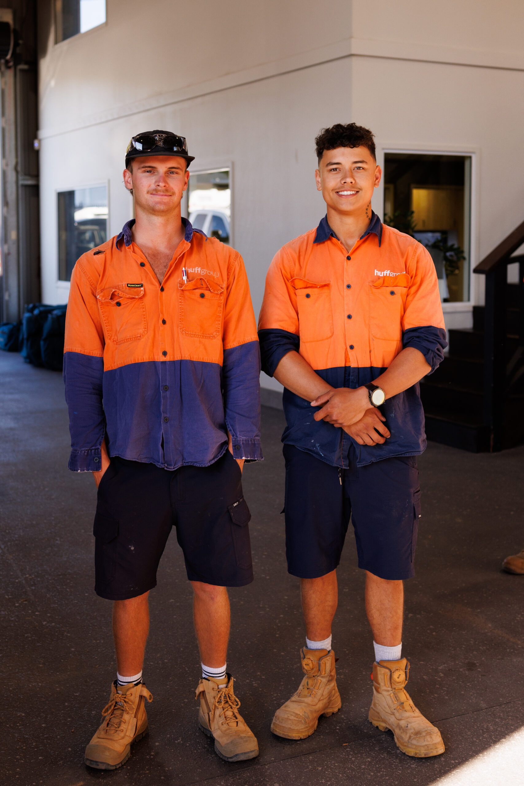 Two Huff Group's worker wearing an orange shirt and a black short