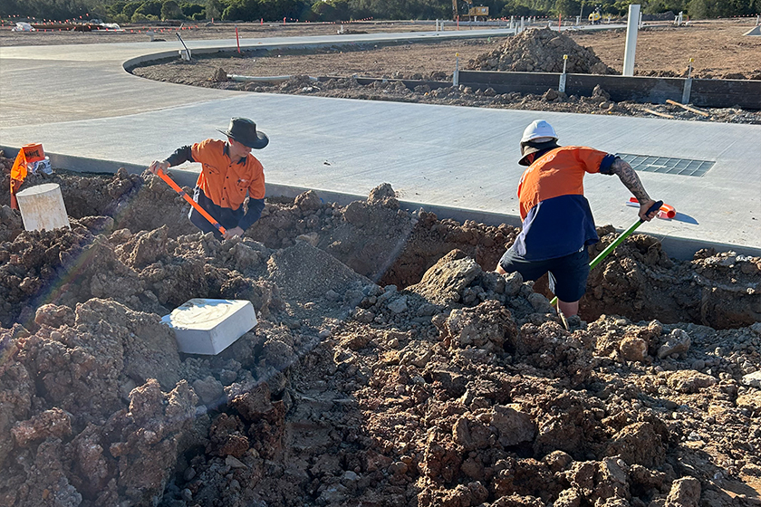 Workers from Huff Group excavate a trench at a construction site for civil electrical services