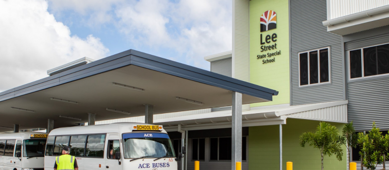 Two school buses parked outside Lee Street State Special School where Huff Group upgraded lighting, power, and data systems for safer, easier learning