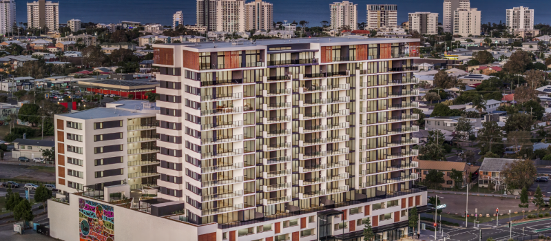 Sunset view of The Corso High-End Apartments, where Huff Group installed premium electrical and advanced building technology systems